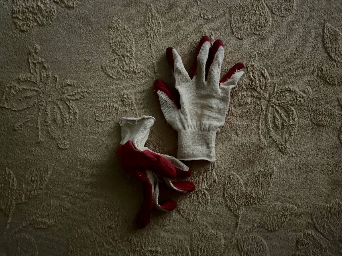 Close-up of heat resistant chemical resistant gloves being used to handle hot cleaning solutions safely in a sustainable home kitchen