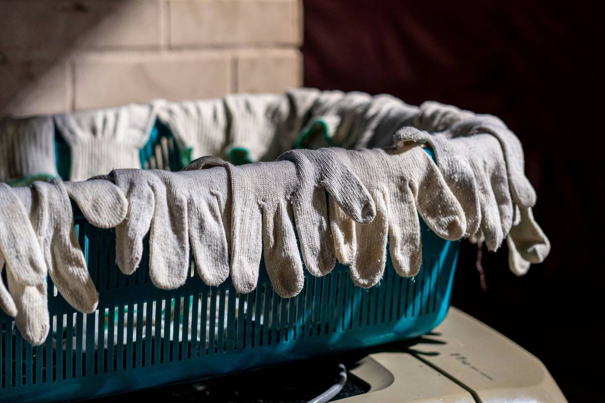 hand wearing diaguru biodegradable gloves scrubbing kitchen sink with citrus cleaner
