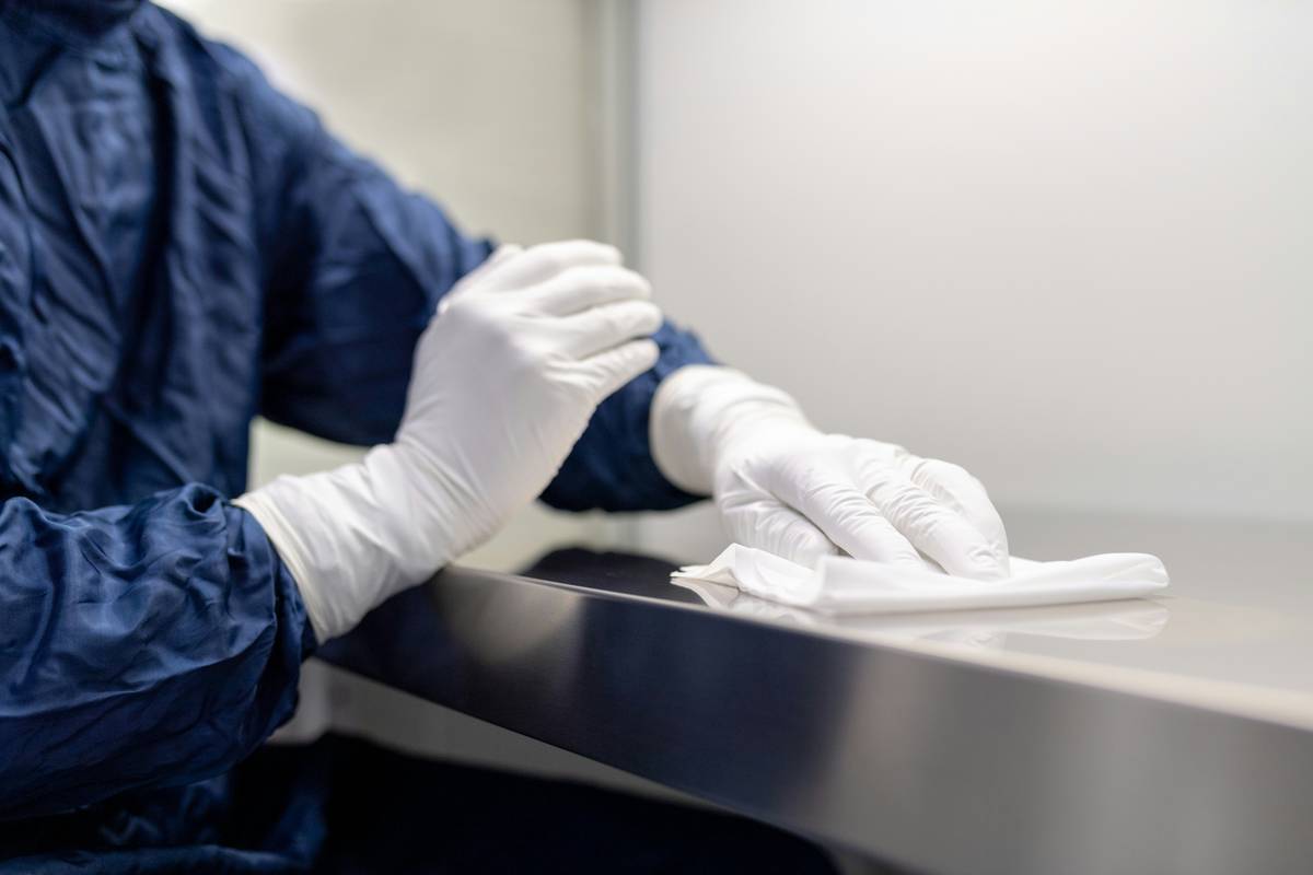 how to clean reusable dishwashing gloves: close-up of rubber gloves soaking in vinegar solution